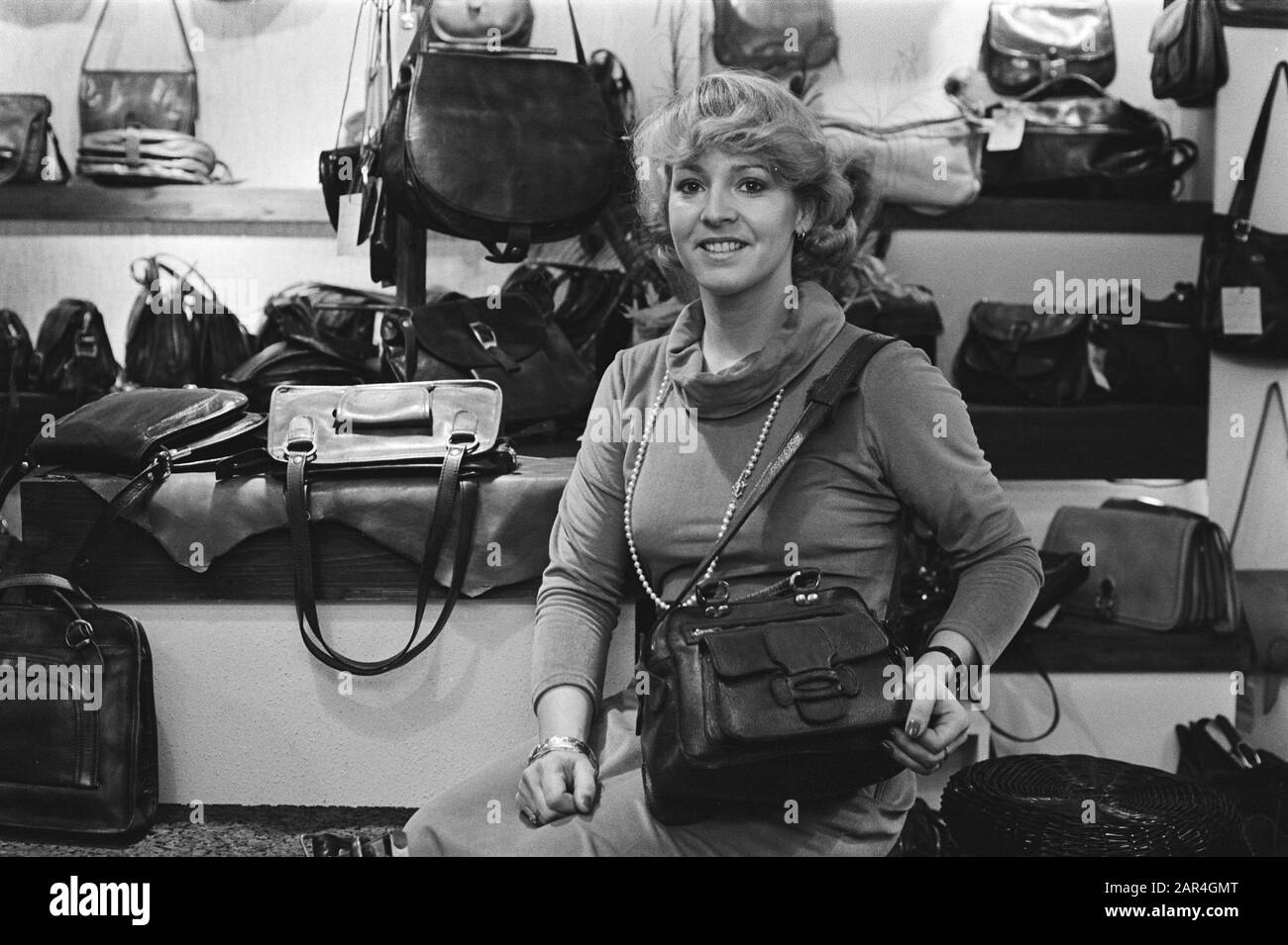 Trains destroyed by football supporters; woman with leather bag Date: 10 January 1977 Keywords: SUPPORTERS, sport, football, women Stock Photo