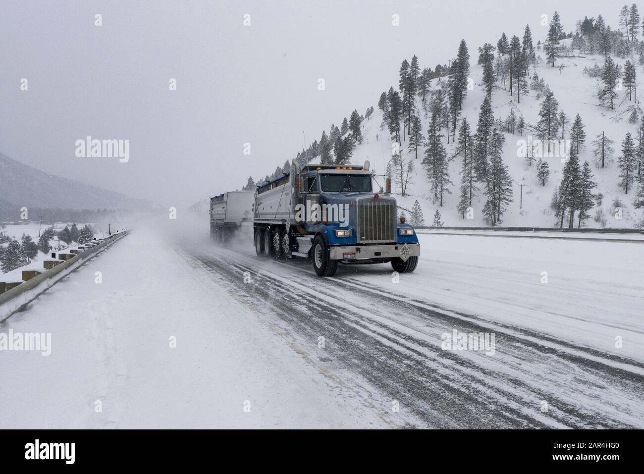 A Kenworth tandem dump truck, on an icedover US Interstate Highway I