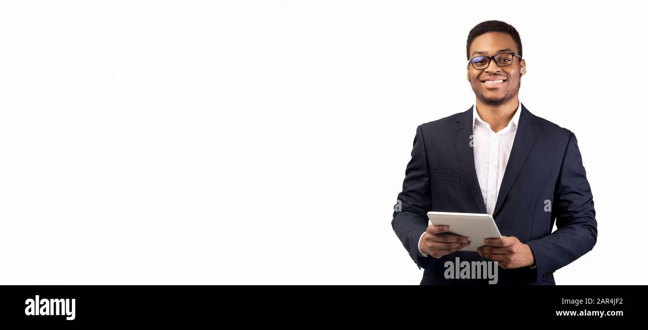 Smiling afro man standing with tablet at studio Stock Photo