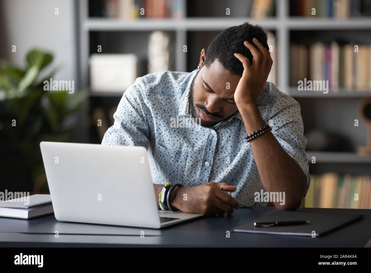 Tired Bored African Employee Falling Asleep Sitting At Work Desk