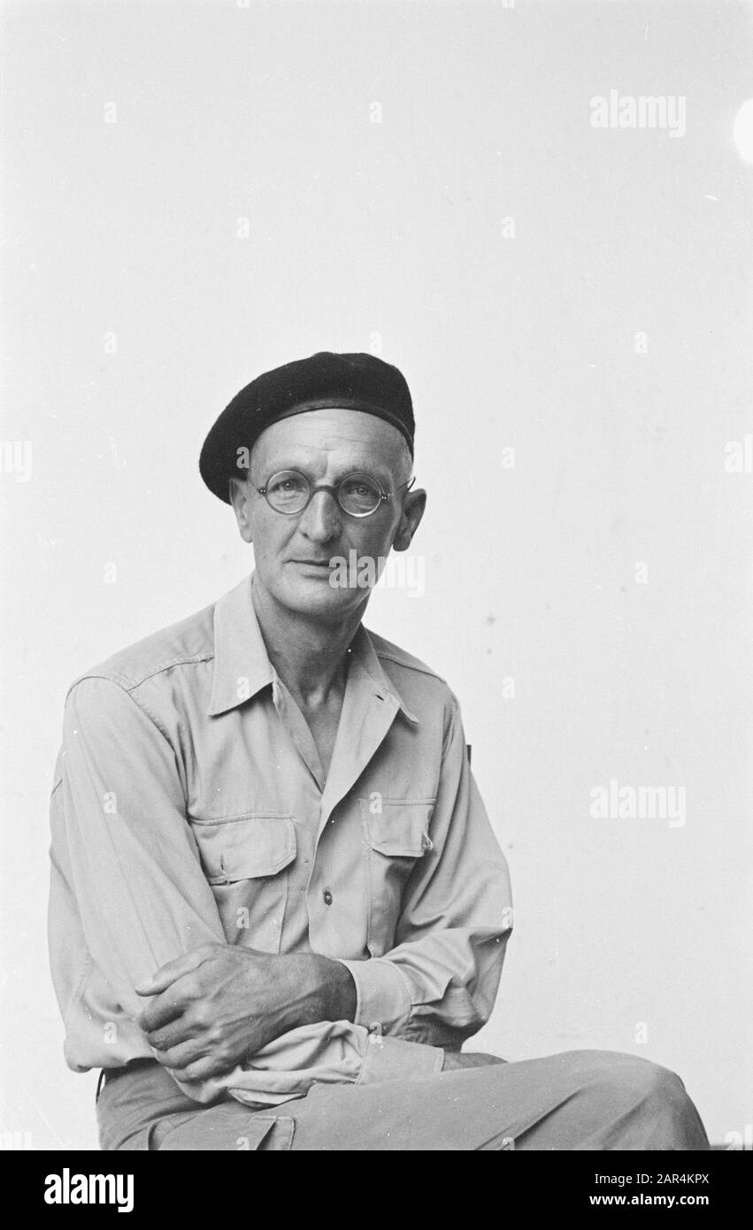 A man in uniform poses. He wears glasses and dark beret Date: april 1947 Location: Indonesia, Dutch East Indies Keywords: portraits Stock Photo