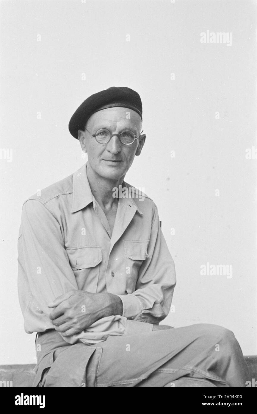 A man in uniform poses. He wears glasses and dark beret Date: april 1947 Location: Indonesia, Dutch East Indies Keywords: portraits Stock Photo