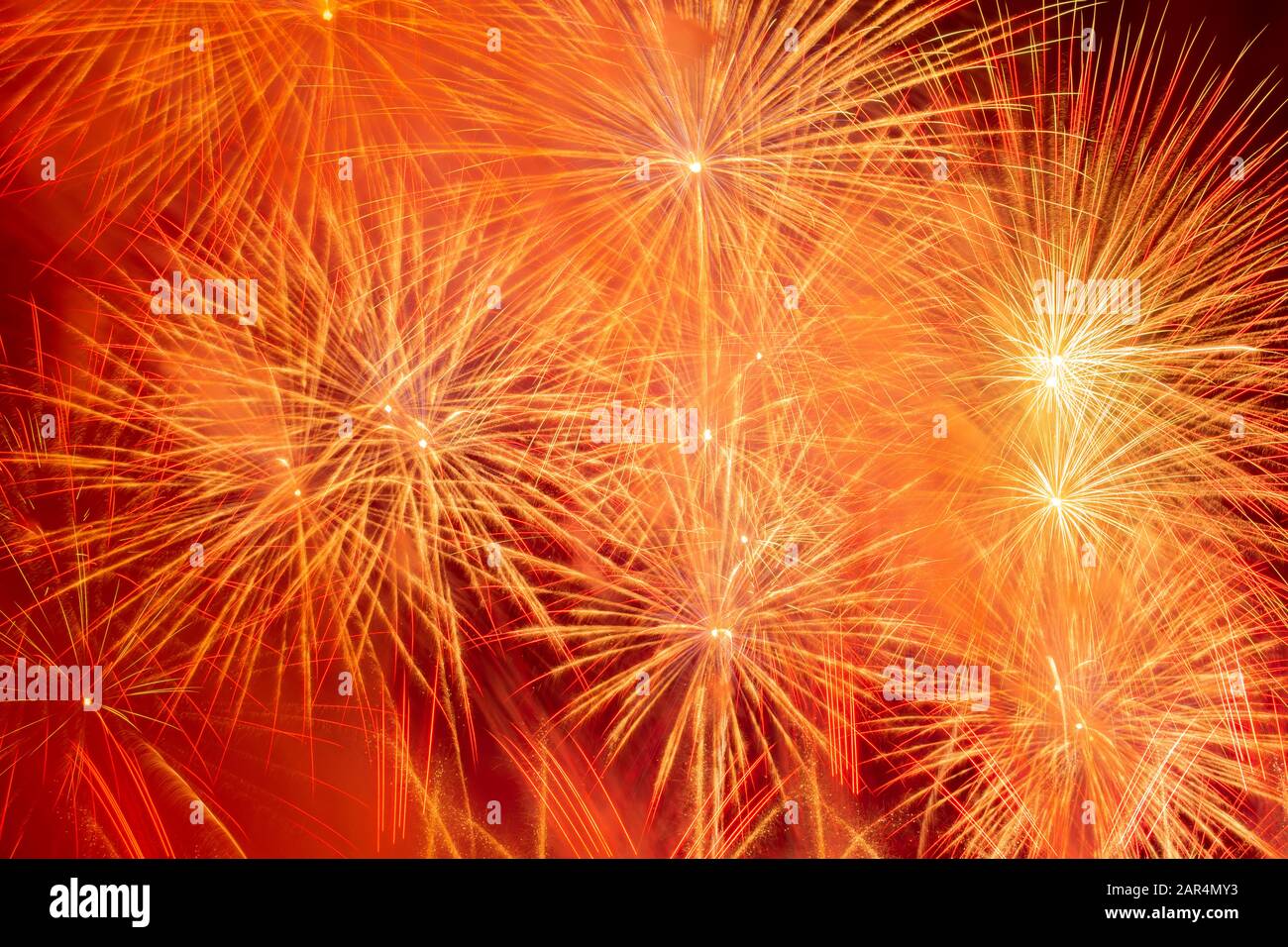 Beautiful orange fireworks display in the urban for celebration on dark