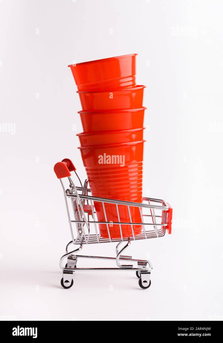Recycling concept with single use plastic cups and shopping cart Stock