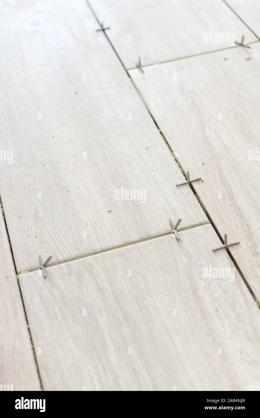Close Up Shot Of Unfinished Floor Tiles Installation In Kitchen