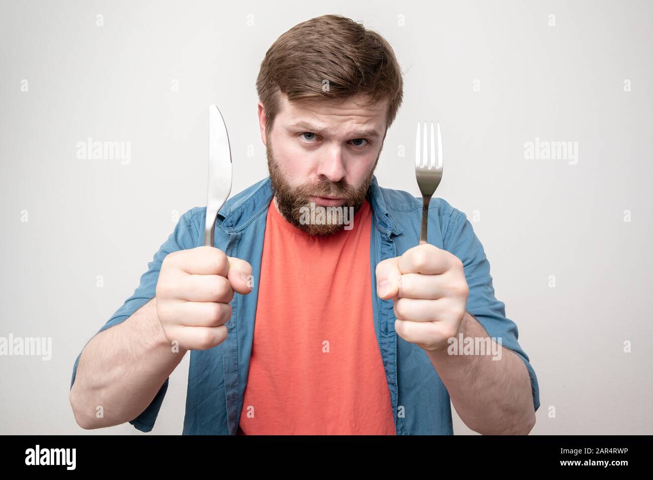 Man holding knife and fork hi-res stock photography and images - Alamy