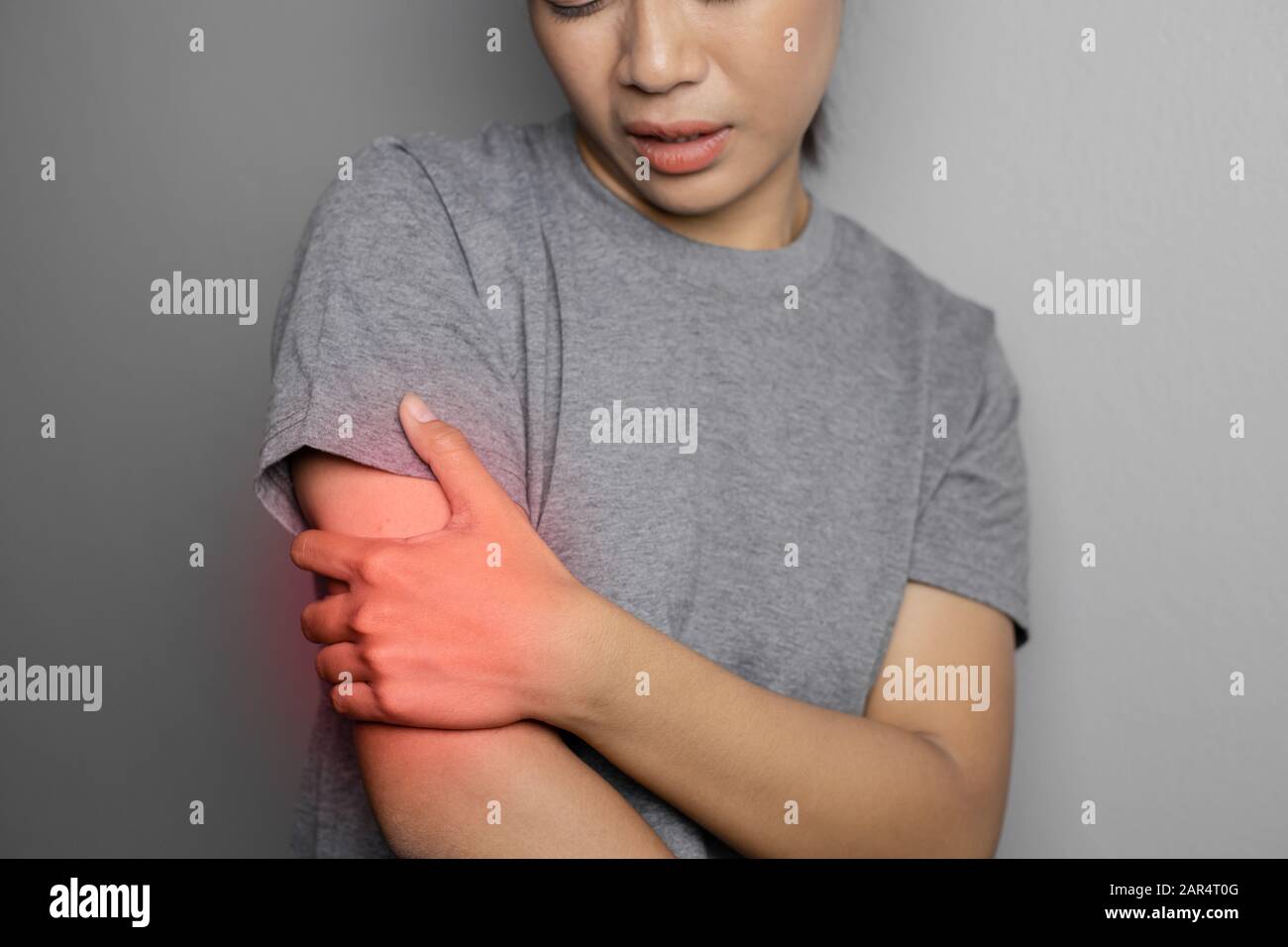 Woman suffering from pain in arm. Concept pain in arm. Young woman with