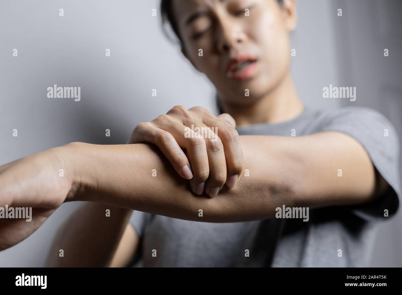 Woman suffering from pain in arm. Concept pain in arm. Young woman with
