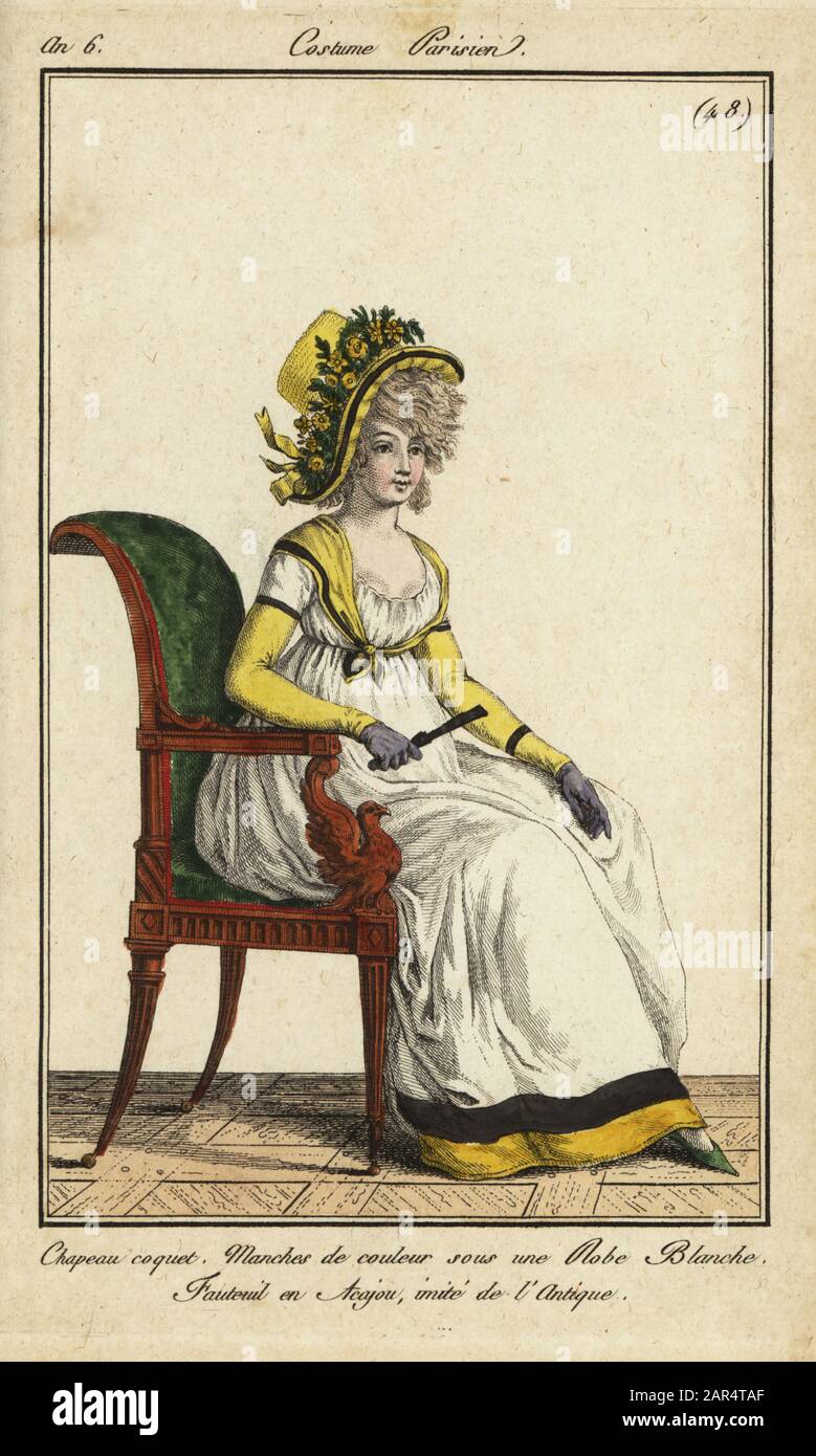 Fashionable woman in an imitation antique chair, 1798. She wears a coquet  hat decorated with flowers and ribbons. Yellow sleeves and yellow kechief  with a white dress. Mahogany chair in an antique