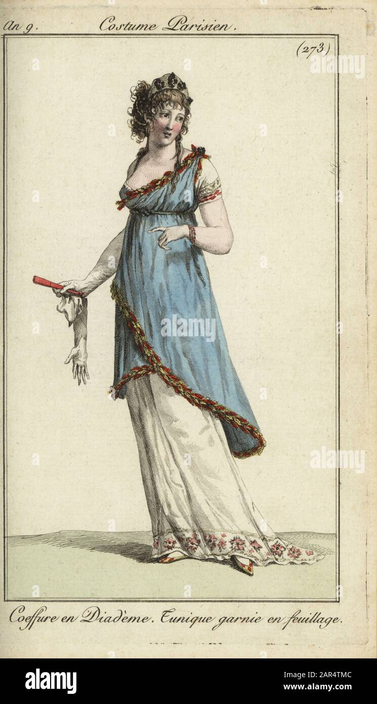 Fashionable woman or merveilleuse in luxurious outfit, 1800. She wears a tiara, a tunic dress decorated with foliage, and carries gloves and a fan. Coeffure en Diademe. Tunique garnie en feuillage. Handcoloured copperplate engraving from Pierre de la Mesangere’s Journal des Modes et Dames, Paris, 1800. The illustrations in volume 4 were by Carle Vernet, Bosio, Dutailly and Philibert Louis Debucourt. Stock Photo
