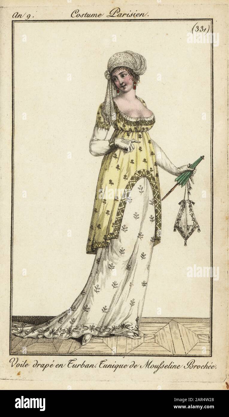 Fashionable woman or Merveilleuse in tunic dress, 1801. She wears a turban with veil, low-cut tunic dress of embroidered muslin. She carries a parasol and ridicule bag. Voile drape en Turban. Tunique de Mousseline Brochee. Handcoloured copperplate engraving from Pierre de la Mesangere’s Journal des Modes et Dames, Paris, 1801. The illustrations in volume 4 were by Carle Vernet, Bosio, Dutailly and Philibert Louis Debucourt. Stock Photo