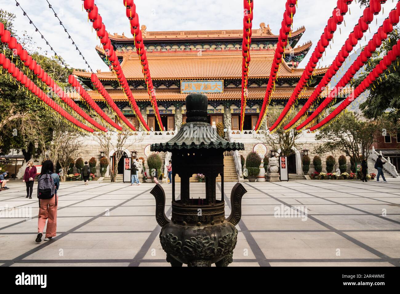 Po Lin Monastery courtyard with traditional Chinese New Year decorations and Hall of Great Hero, Lantau Island, Hong Kong Stock Photo