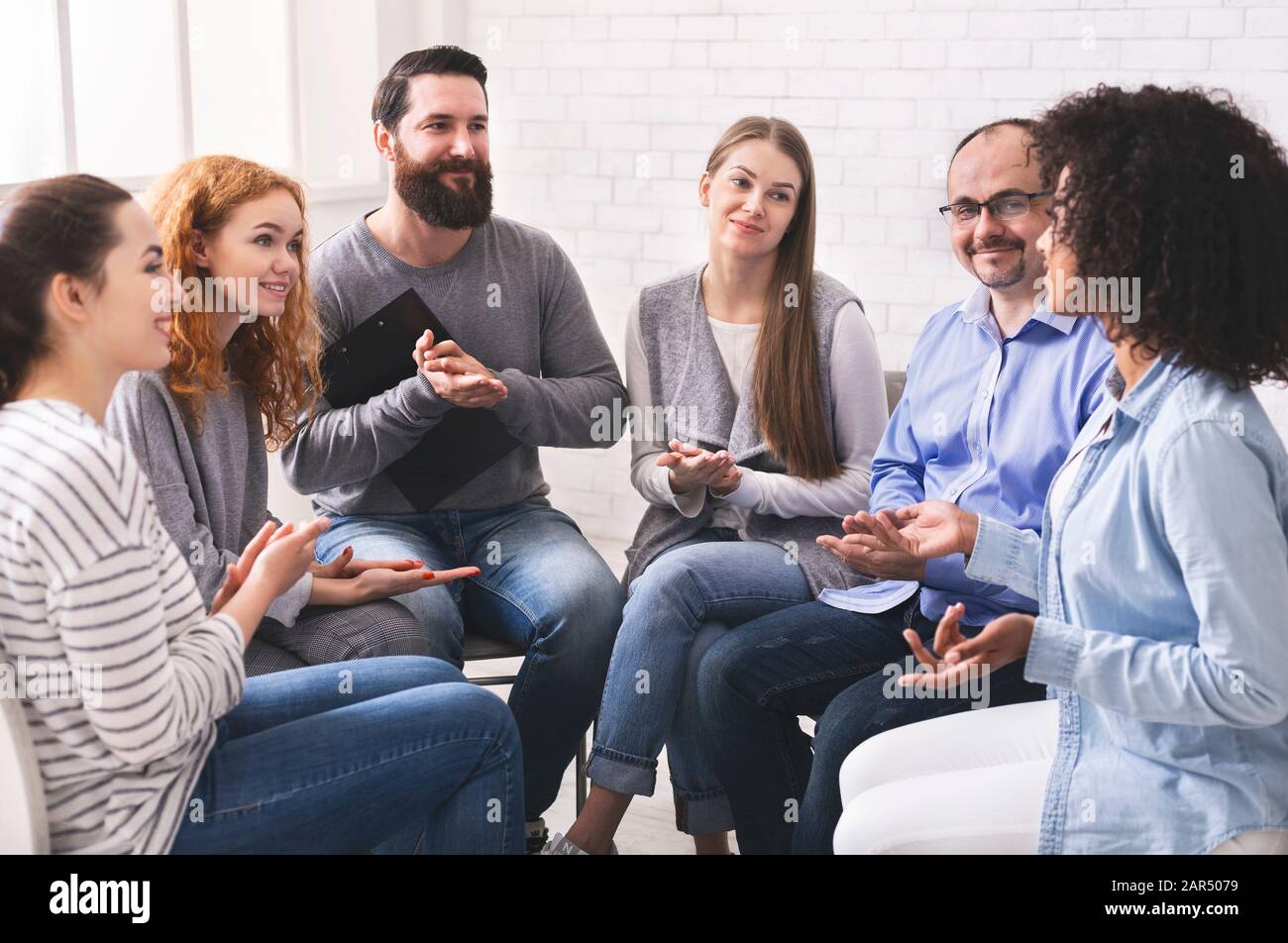 Young woman sharing her story at group therapy session in rehab Stock Photo