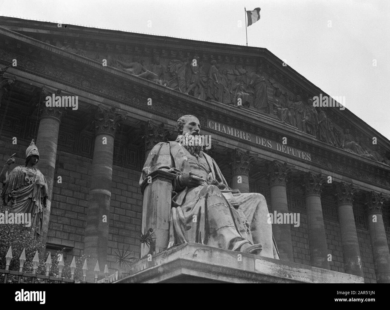 Reportage Paris  Facade of the French parliament building Annotation: Since 1827 the House of the French Parliament has been sitting here. Until 1946 under the name Chambre des Deputes, then Assemblée Nationale. The statue is of one of the ministers of the French King Date: 1935 Location: France, Paris Keywords: sculptures, parliament buildings Stock Photo