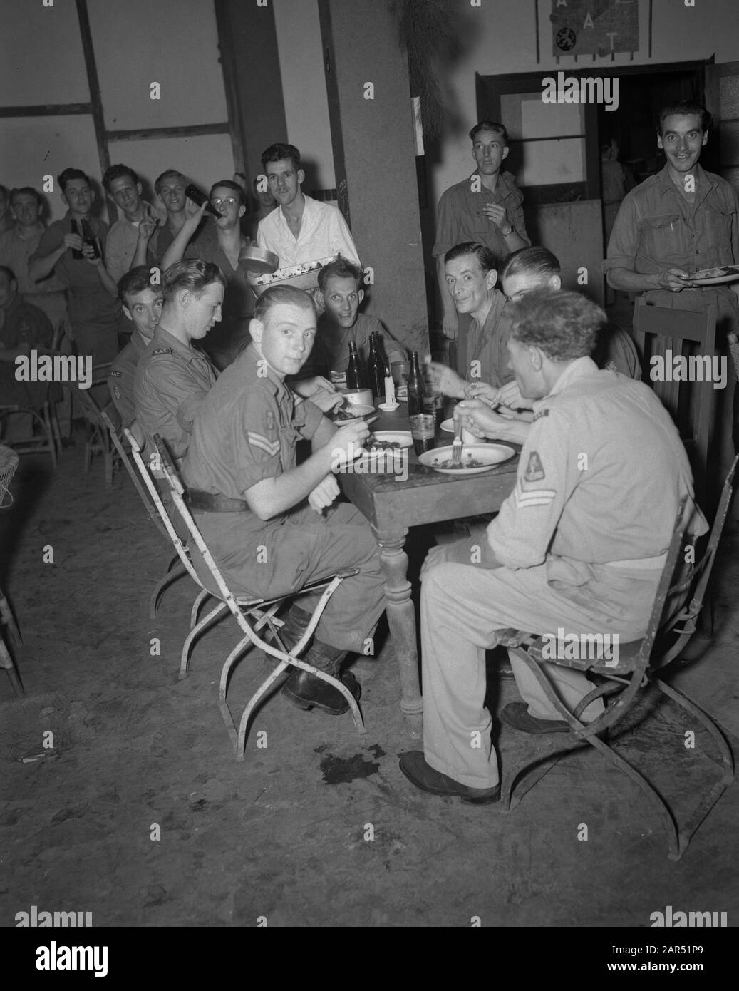 Joint meal during the Christmas celebration Annotation: A.A.T.-ers Date: 25 December 1946 Location: Indonesia, Dutch-Indies Stock Photo