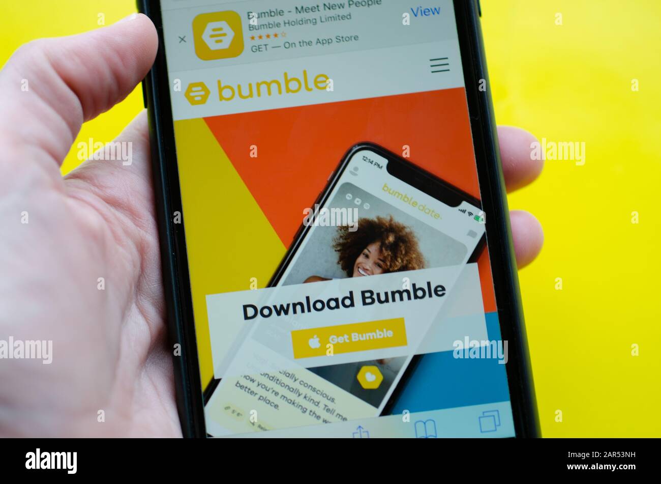 Gibraltar 23 January 2020: Hand holding an iPhone displaying the Bumble app ready for download Stock Photo