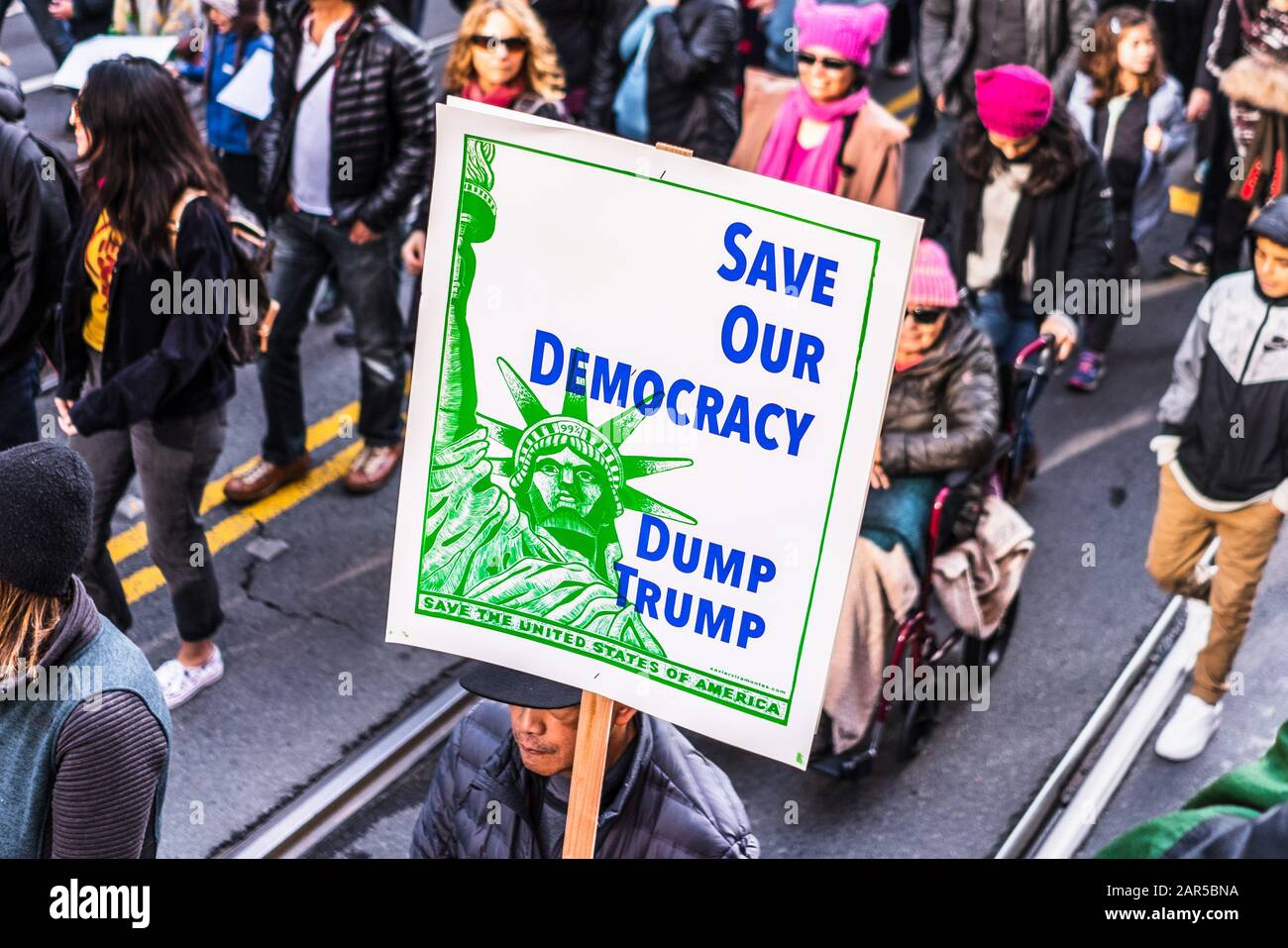 Jan 18, 2020 San Francisco / CA / USA - Participant to the Women's March event holds a sign asking for Trump's removal while marching on Market street Stock Photo