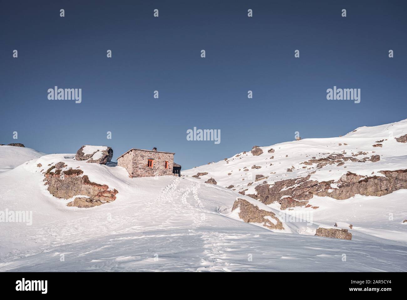 Scary lake shelter at winter in front of frozen lake in Rila mountain national park, Bulgaria Stock Photo