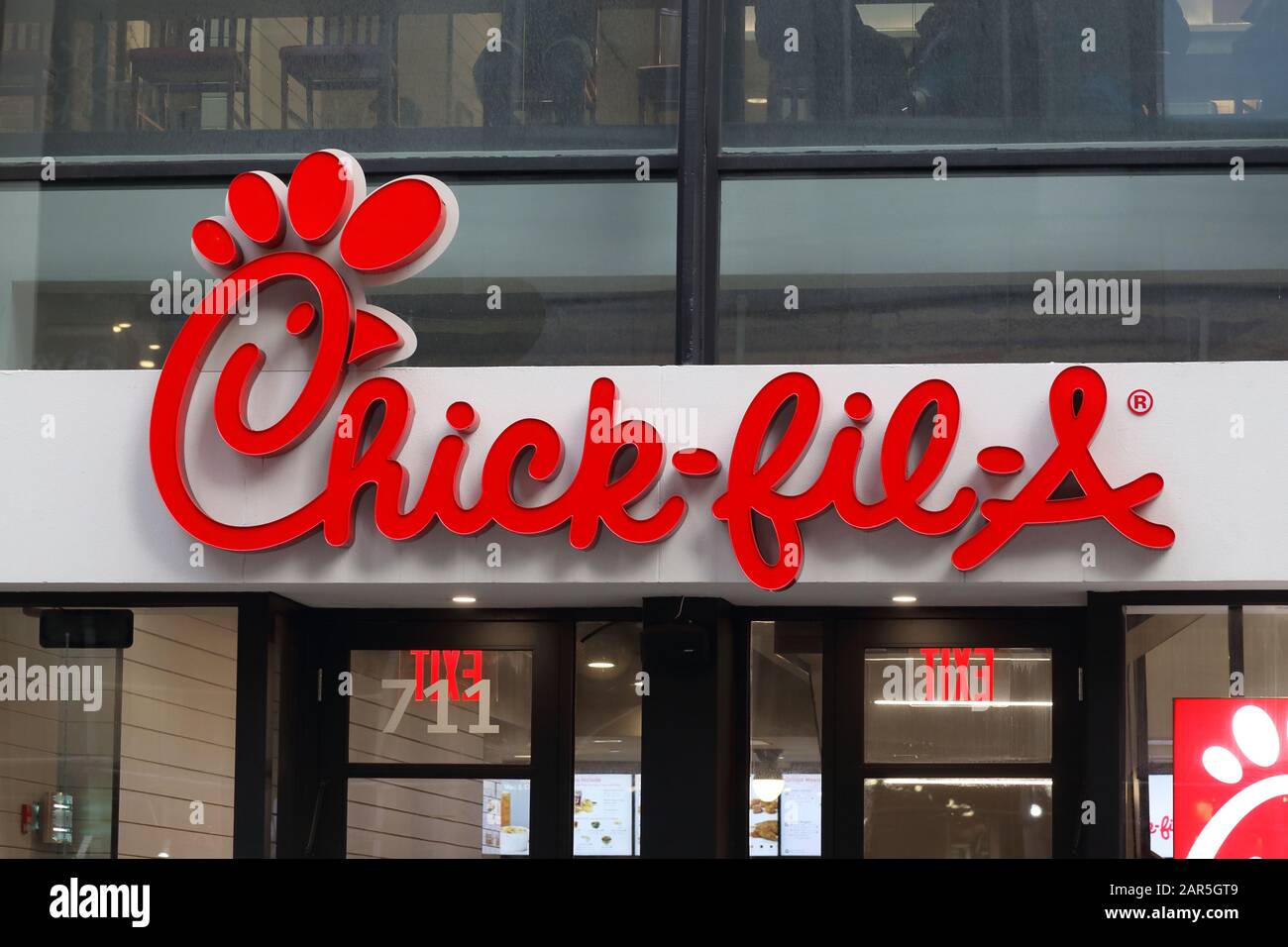 A Chick-fil-A logo on one of their stores on Lexington Ave, Manhattan, New York, NY. Stock Photo