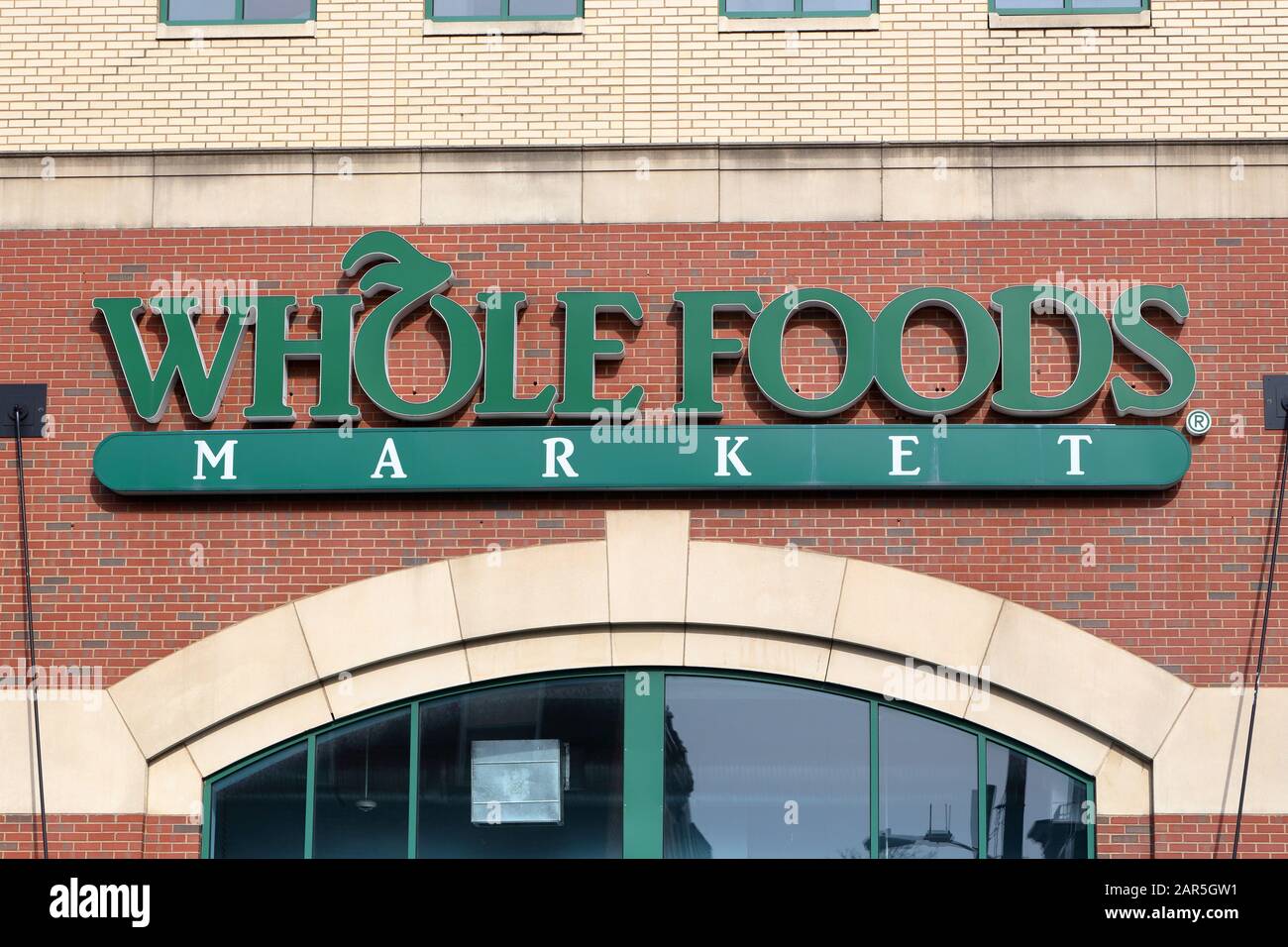 A Whole Foods Market logo against a brick wall at one of their stores in Center City, Philadelphia, PA. Stock Photo