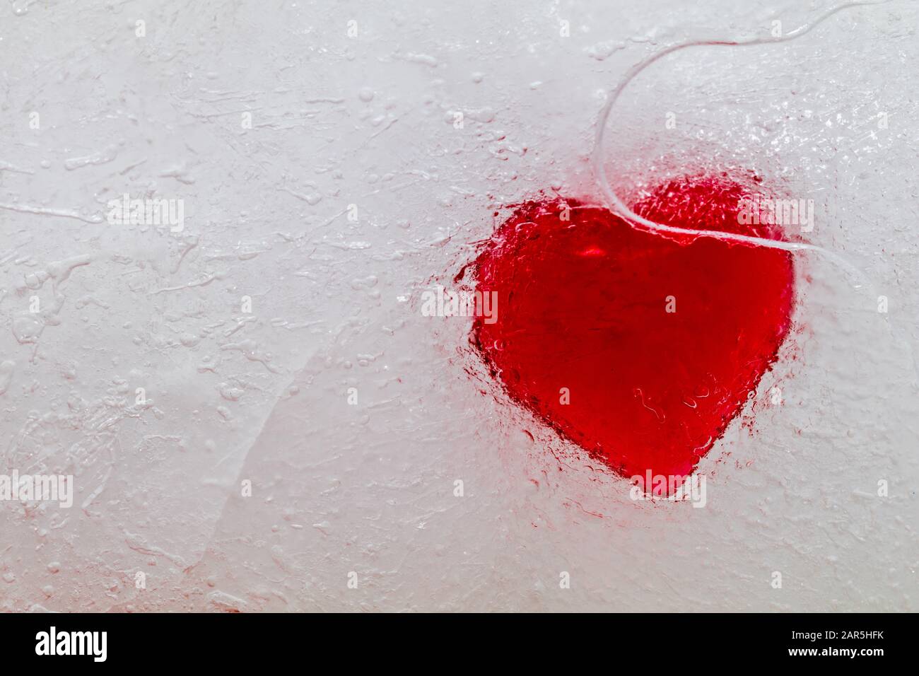 Abstract frozen heart in ice concept of heartbreak no love Stock Photo