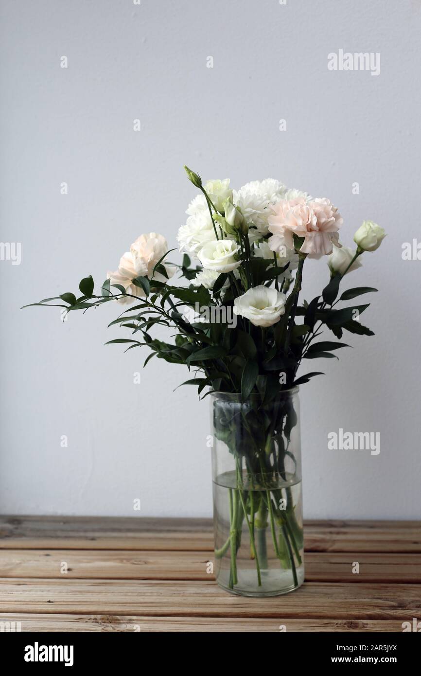 Super cute, light color flower bouquets including baby pink and white dianthus flowers with white chrysanthemum flowers, and some other white flowers. Stock Photo