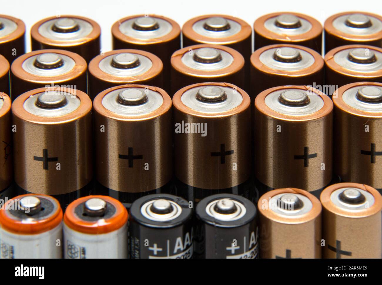 Stack, row of alkaline batteries, AA, AAA, cells,power, not recycleable, non recycle. Stock Photo