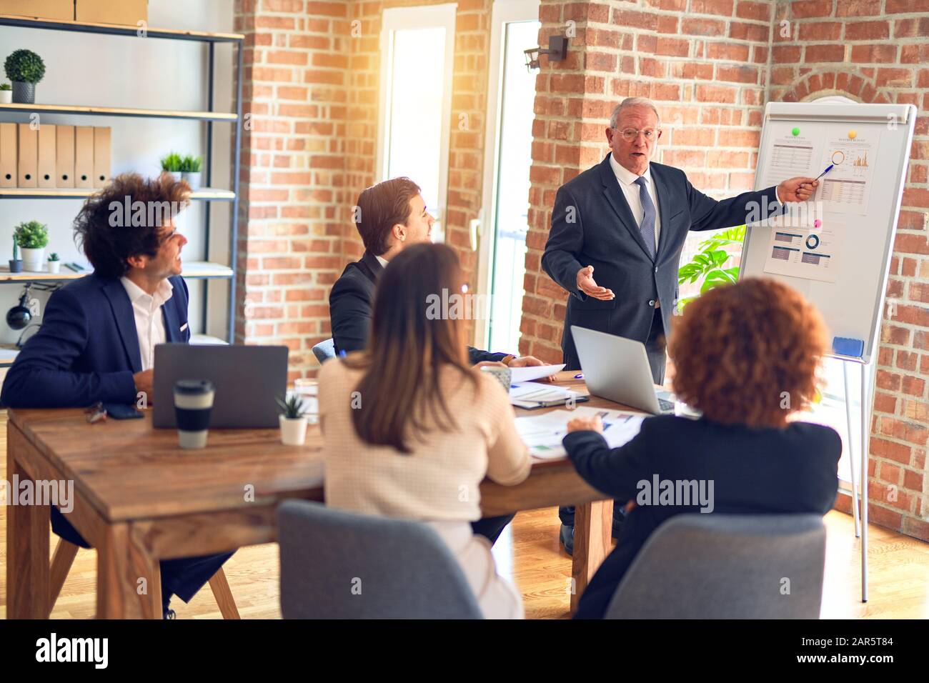 Group of business workers smiling happy and confident in a meeting