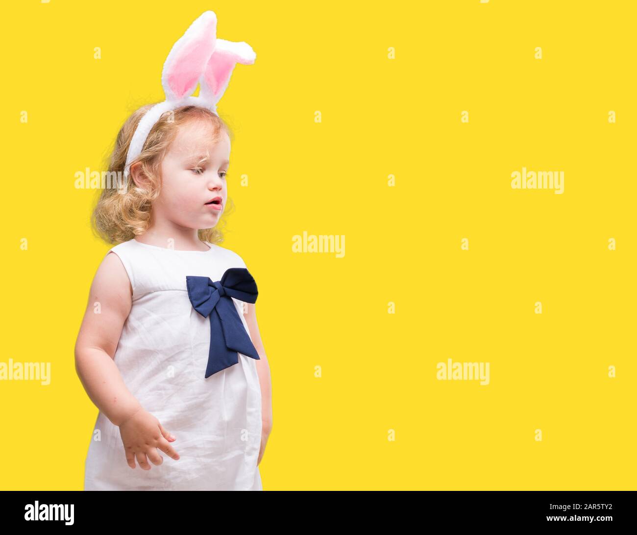 Lovely Blonde Toddler Wearing Easter Bunny Ears Stock Photo