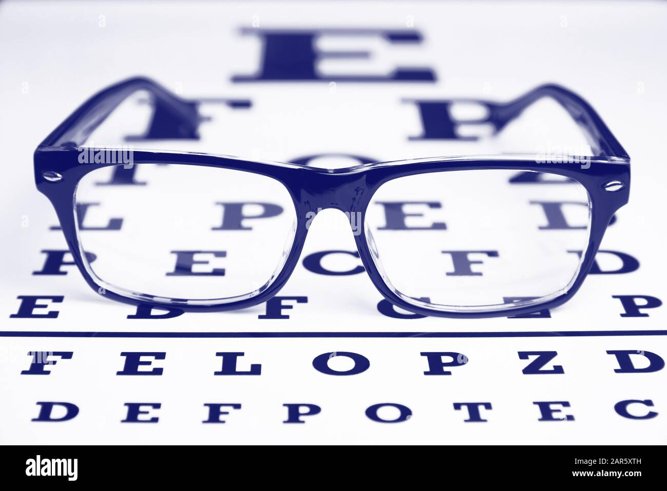 Glasses on the chart for eye examination. Stock Photo