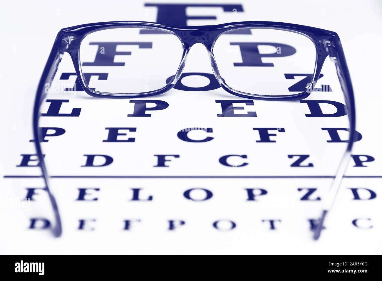 Glasses on the chart for eye examination. Stock Photo