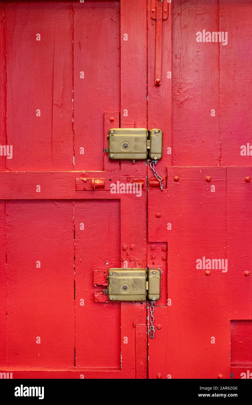 Old red gate with manual lock Stock Photo - Alamy