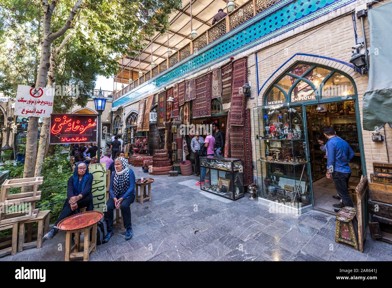 Small courtyard with a shops and teahouse on Bazaar of Isfahan next to Naqsh-e Jahan Square (Imam Square, formlerly Shah Square) in Isfahan, Iran Stock Photo