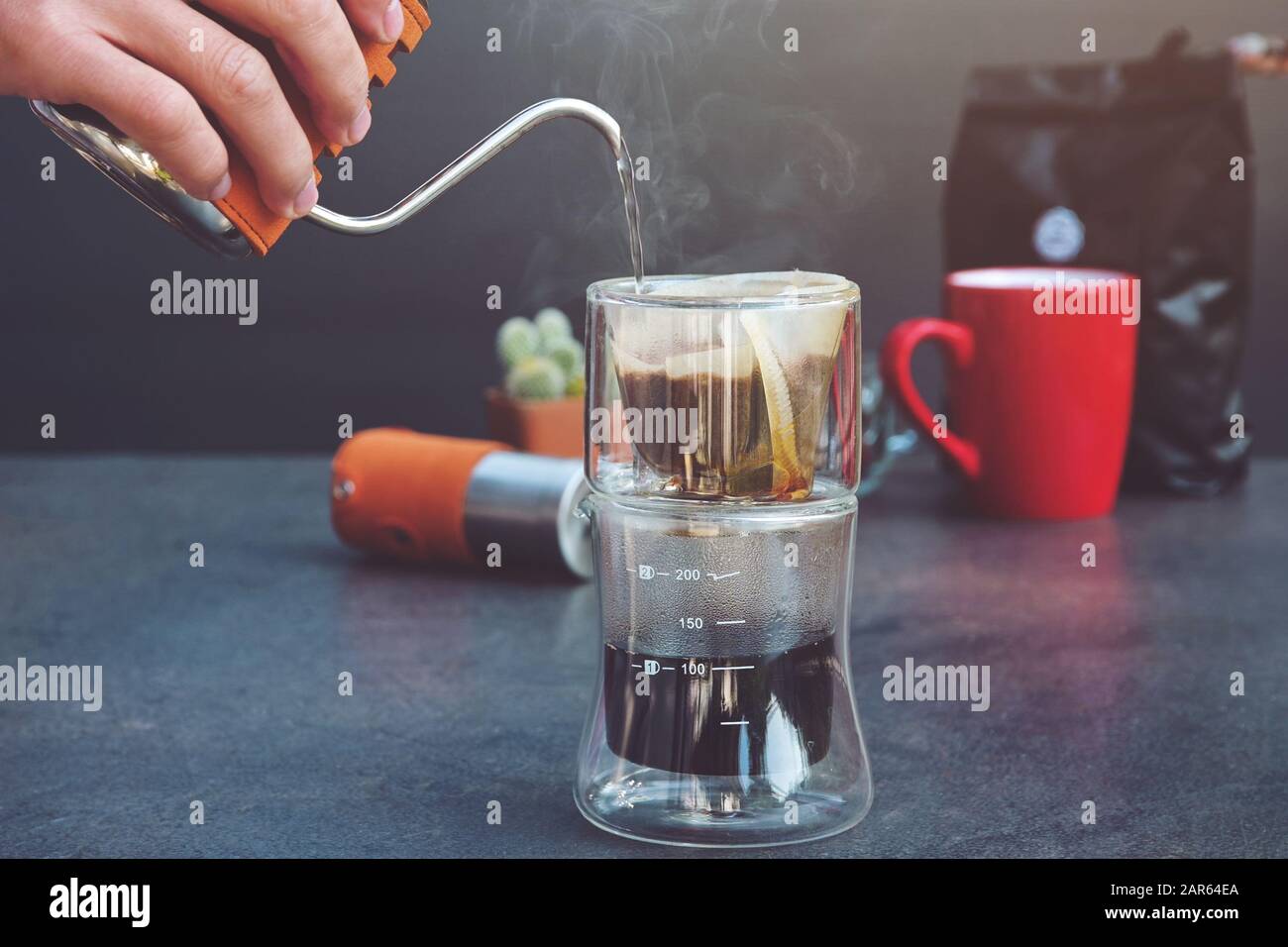 Drip Brew Coffee Caffeine Filter Flavor Mug Cup. Man spills hot water