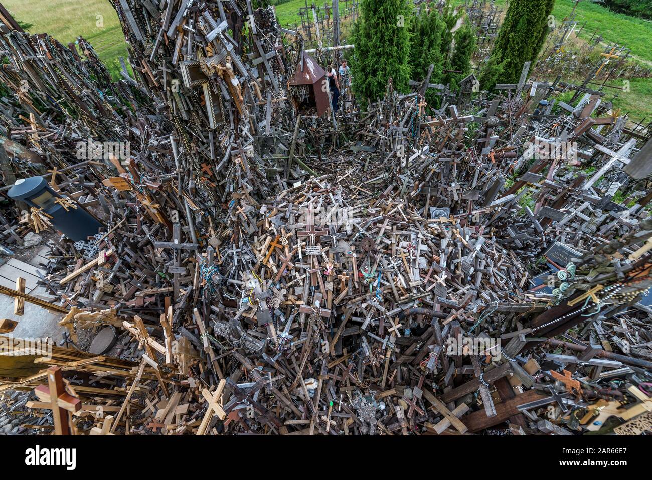 Heap of small crosses brought by pilgrims on Hill of Crosses in Lithuania Stock Photo