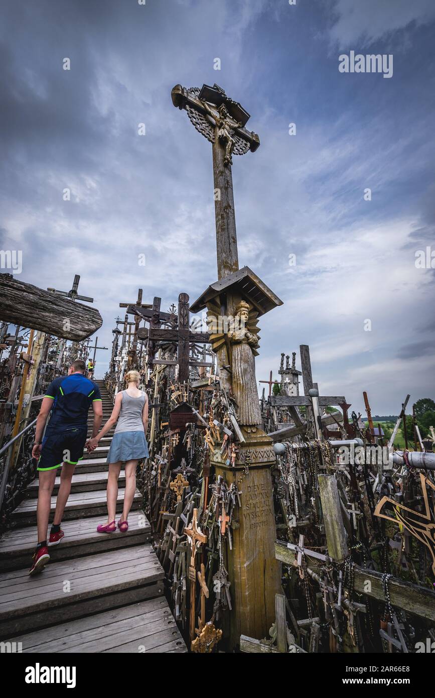 Tourists on Hill of Crosses in Lithuania Stock Photo