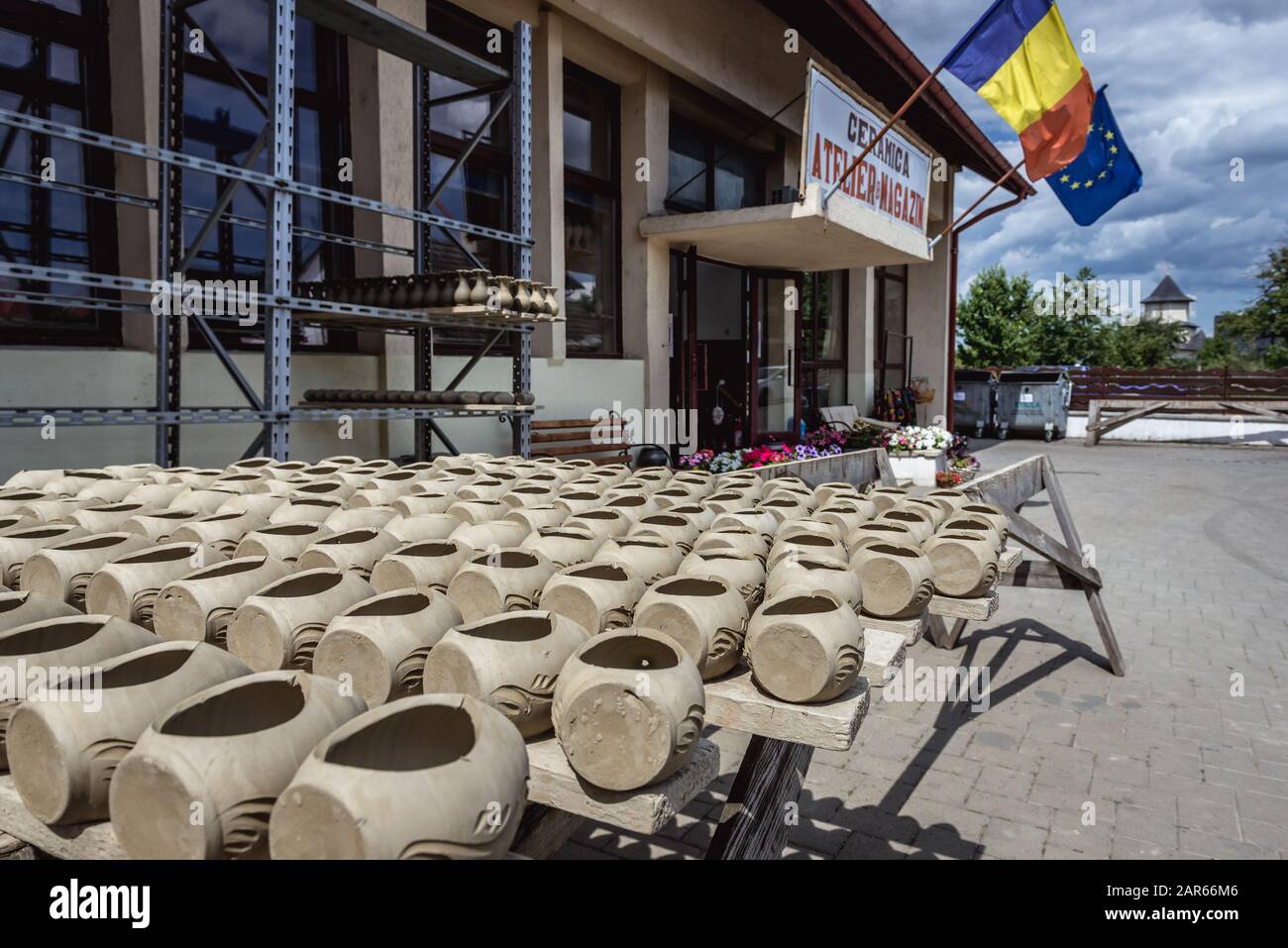 Handmade vessels drying on sun in front of Black Ceramics of Marginea centre, famous for its ancient burning technique in Marginea village, Romania Stock Photo