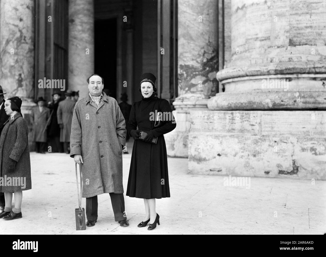 Rome: Visit to Vatican City Lee Garmes and his wife in front of the  entrance to St. Peter's Basilica Date: December 1937 Location: Italy, Rome,  Vatican City Keywords: church buildings, men, pillars,