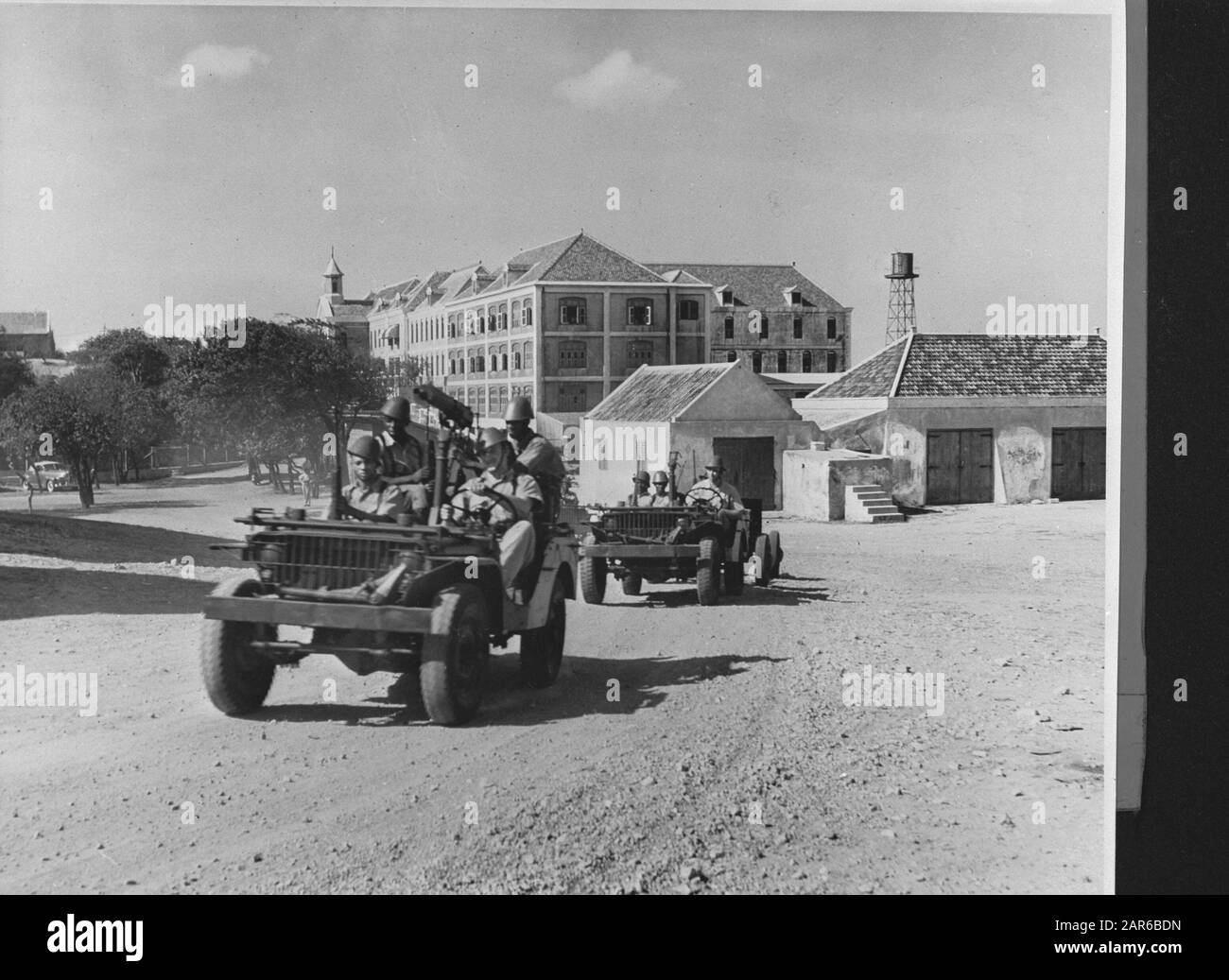 Wi [West Indies]/Anefo London series  Light mechanized squads of the Dutch garrison with American-made jeeps. In the backgroung: the barracks at Willemstad, the island capital [light mechanized units of the Dutch garrison with American Willy jeeps. In the background the barracks in Willemstad] Annotation: Repronegative Date: {1940-1945} Location: Curaçao, Willemstad Keywords: army, tanks, second world war Stock Photo