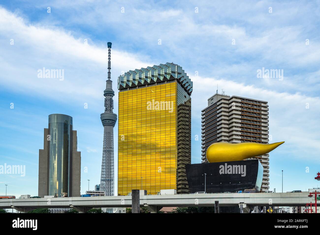 Sky Tree tv tower building with the Asahi building headquarters along Sumida river, Tokyo Stock Photo
