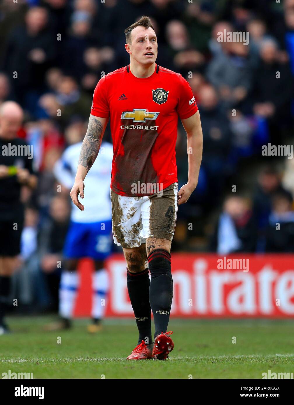Manchester United's Phil Jones covered in mud during the FA Cup fourth round match at Prenton Park, Birkenhead. Stock Photo