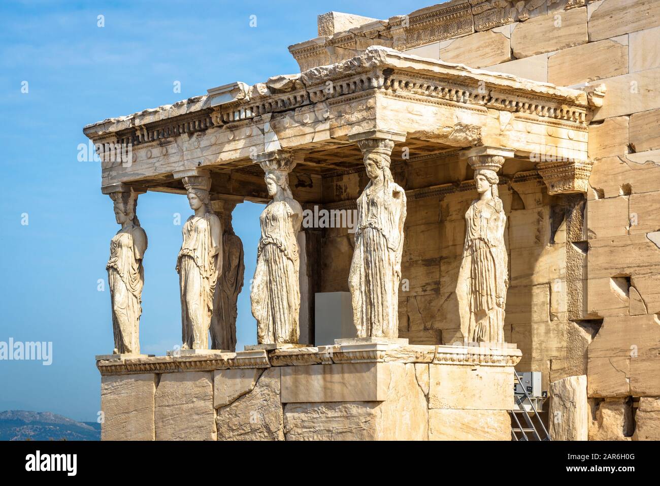 Caryatid Porch of the old Erechtheion temple, Athens, Greece. It is a famous landmark of Athens. Beautiful antique statues of Caryatids close-up. Anci Stock Photo