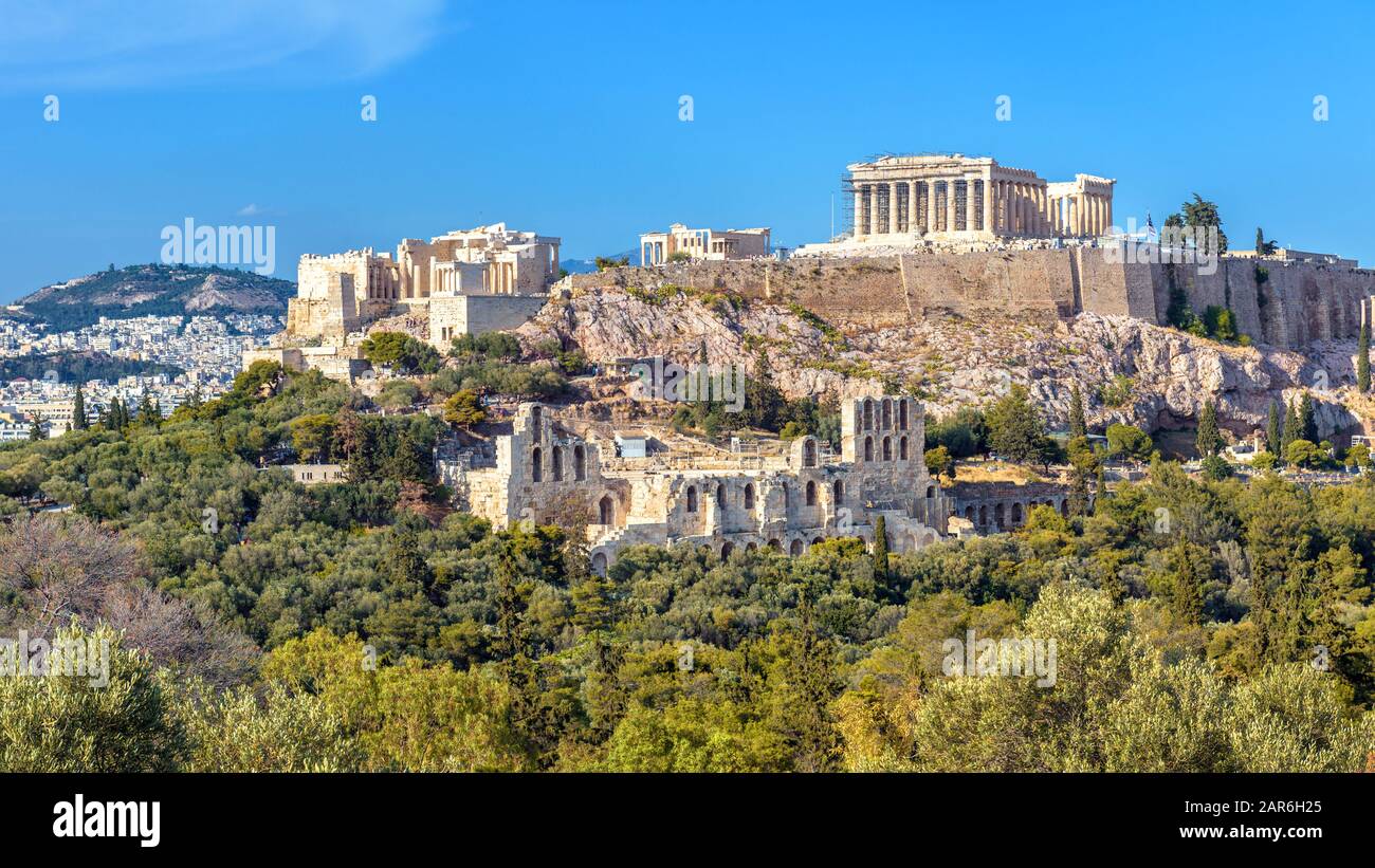 Acropolis of Athens in summer, Greece. View of famous Parthenon and Odeon of Herodes. Urban landscape of old Athens with classical Greek ruins. Scenic Stock Photo