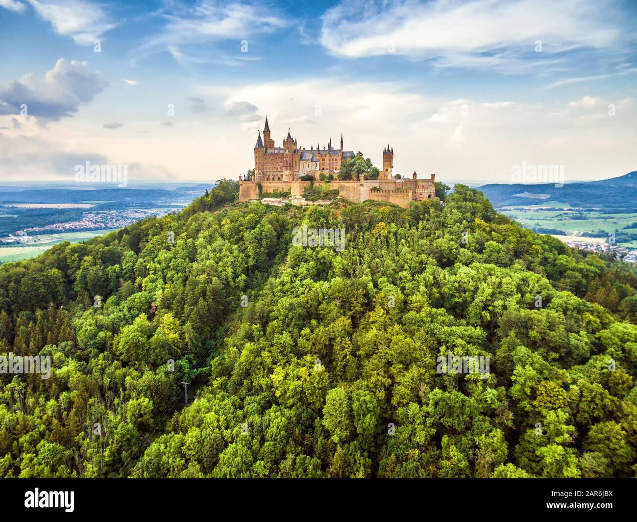 Hohenzollern Castle on mountain top, Germany. This fairytale castle is famous landmark in Stuttgart vicinity. Aerial view of Burg Hohenzollern in summ Stock Photo