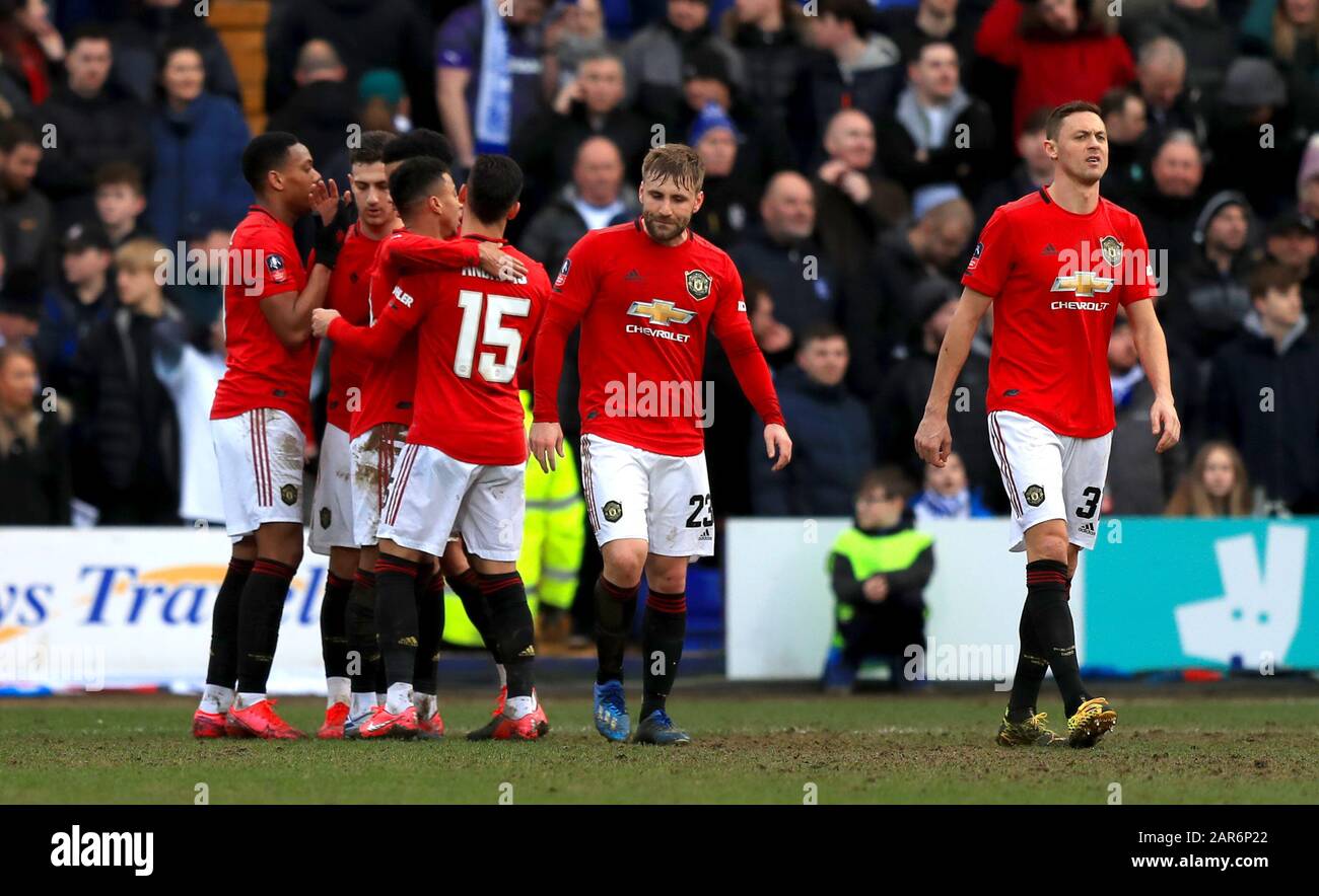 Manchester United's Anthony Martial (left) celebrates scoring his side's fifth goal of the game with team mates during the FA Cup fourth round match at Prenton Park, Birkenhead. Stock Photo