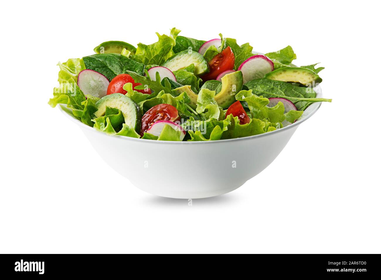 Green salad with avocado, tomato and fresh vegetables isolated on white background Stock Photo
