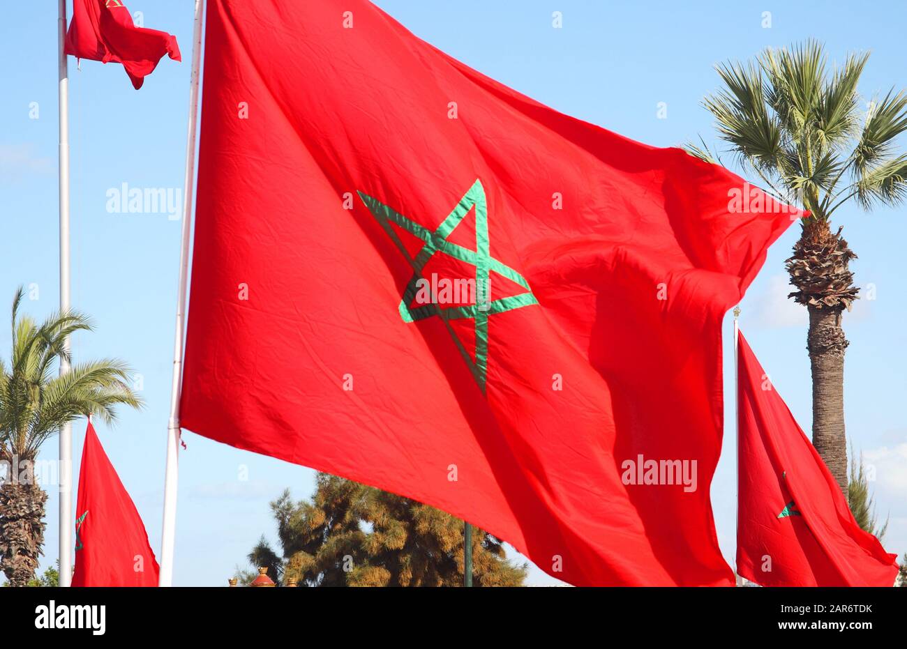 Moroccan flags flying near the Mausoleum of Mohammed V and Hassan Tower, Rabat, Morocco Stock Photo