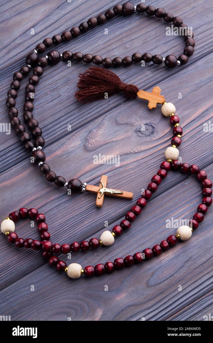 Brown and red rosaries on wood. Stock Photo