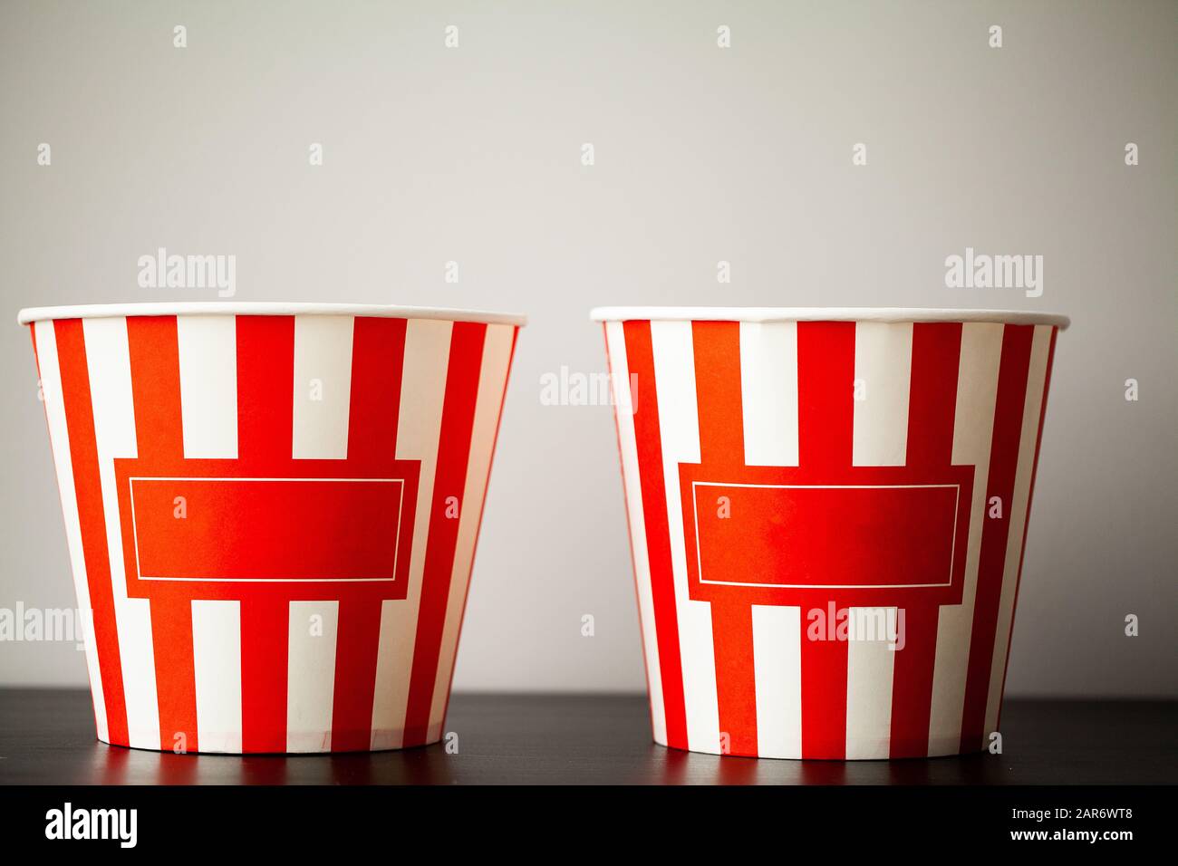 Striped box with popcorn on wood desk Stock Photo