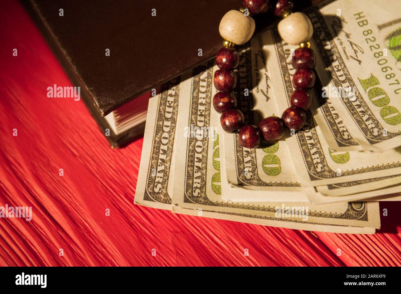Prayer rosary beads, bible and money. Stock Photo